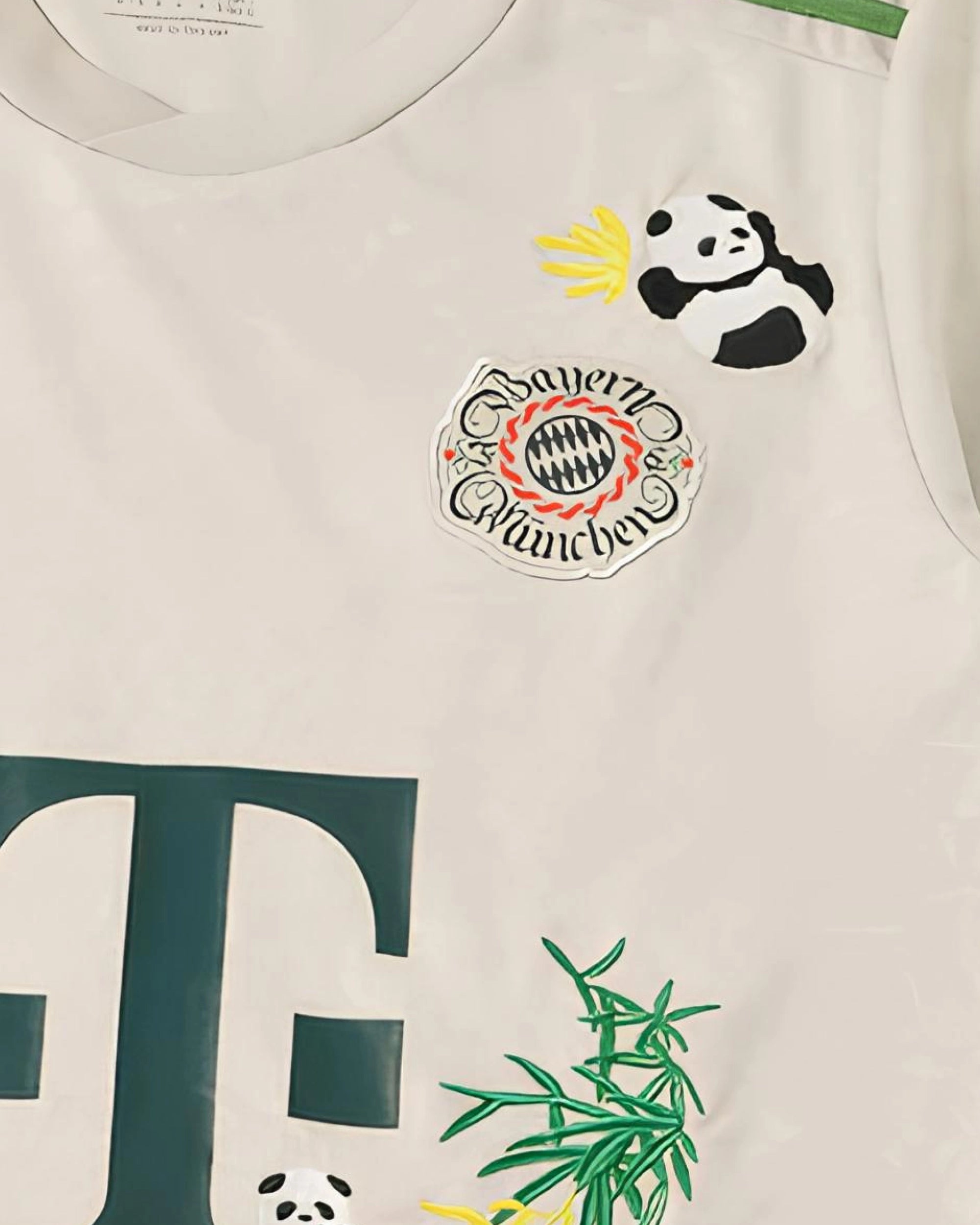 Bayern Munich badge detail with hand-embroidered giant panda cub above crest on stone beige concept jersey — artisanal embroidery Paris & Versailles — VOLTA Hellabrunn Edition