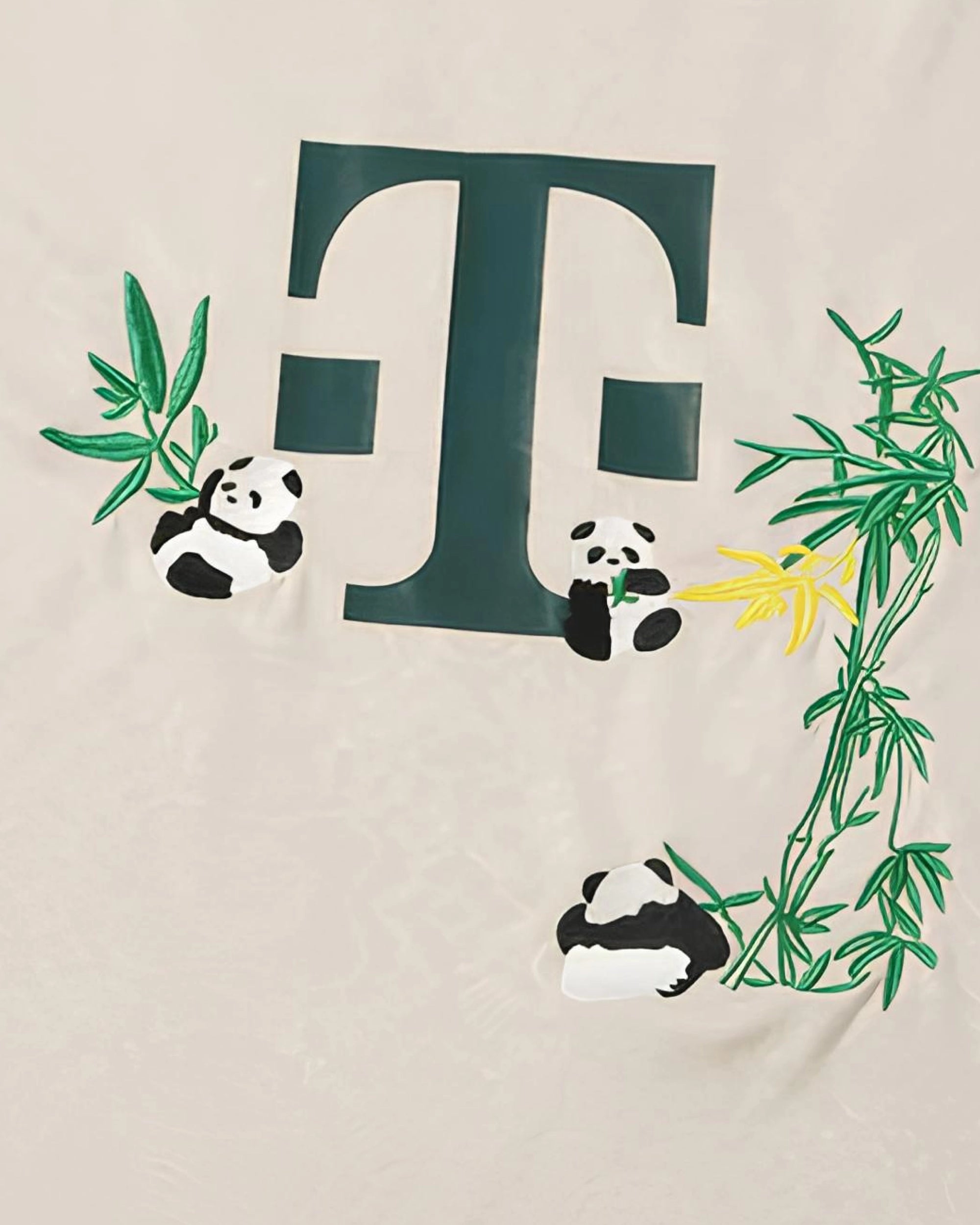 Hand-embroidered giant pandas playing among green bamboo branches on Bayern Munich concept jersey — botanical panda embroidery Paris & Versailles — VOLTA Hellabrunn Edition