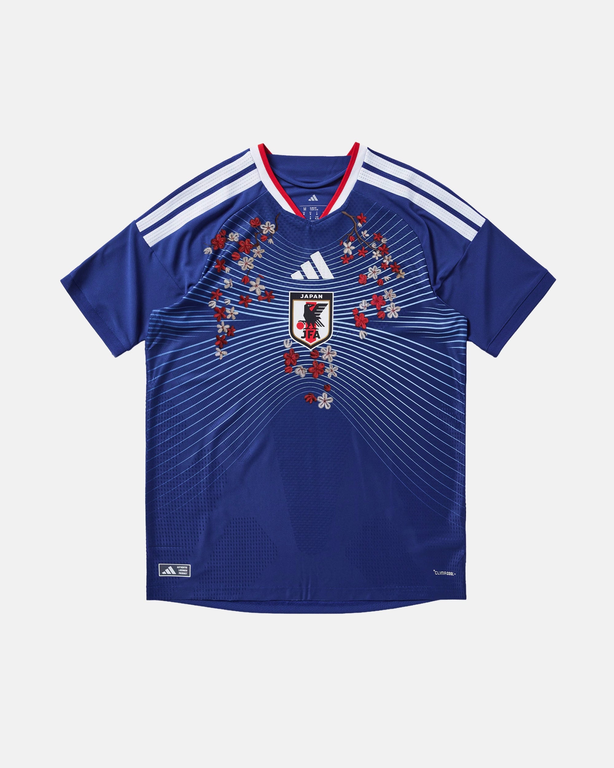 Full front view of the bespoke Japan 'Imperial Bloom' Edition Japan Embroidered Kit, showing the deep indigo blue base with symmetrical gold botanical embroidery cascading around the JFA crest and trefoil logo.
