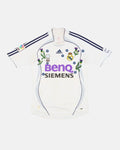 Real Madrid hand-embroidered retro concept jersey front view — Scottish thistle and blue forget-me-not botanical art on authentic 2006/07 white base — VOLTA Galáctico Garden Edition