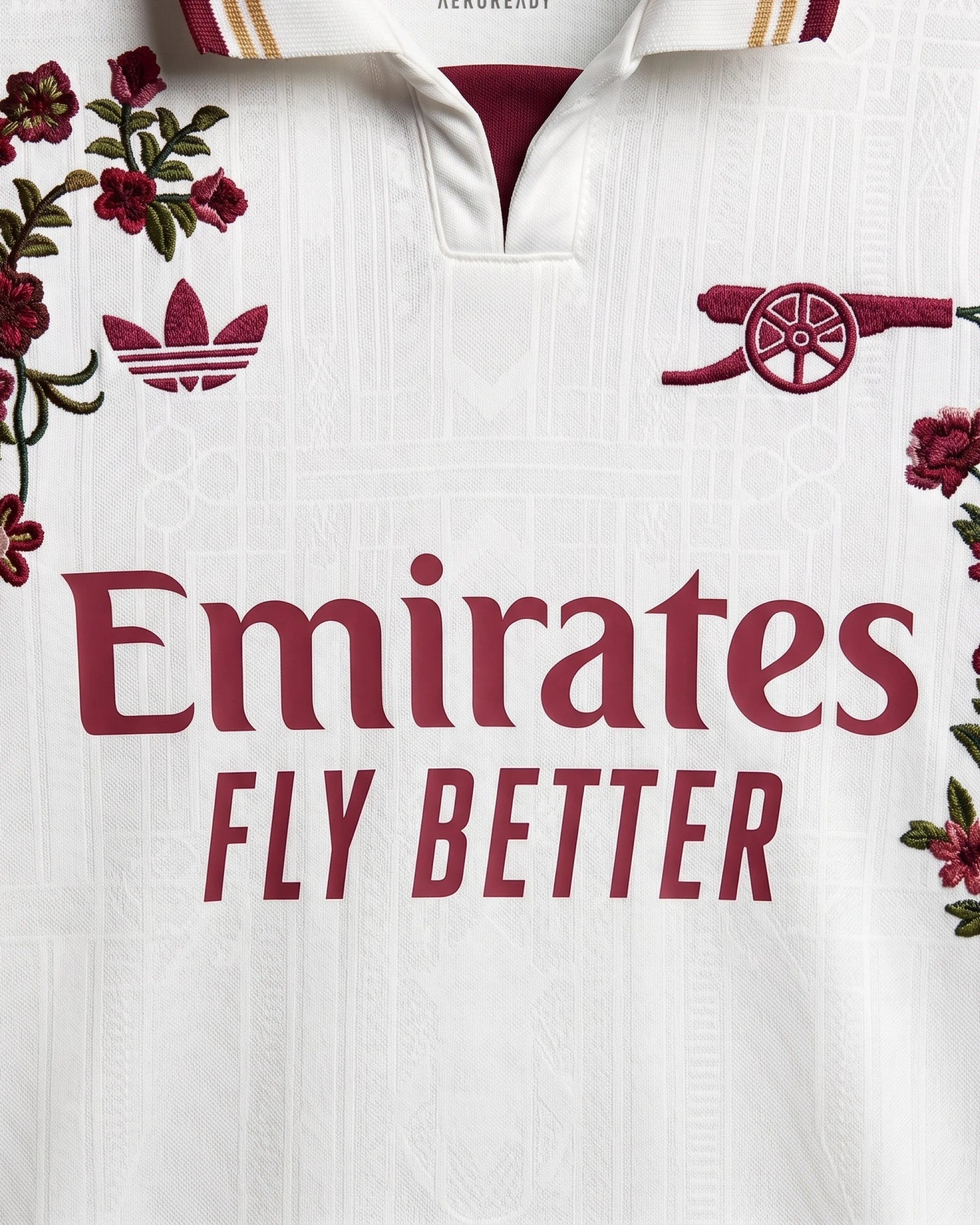 Close-up hand-embroidered crimson and burgundy floral detail on Arsenal concept jersey — botanical embroidery Paris & Versailles — VOLTA