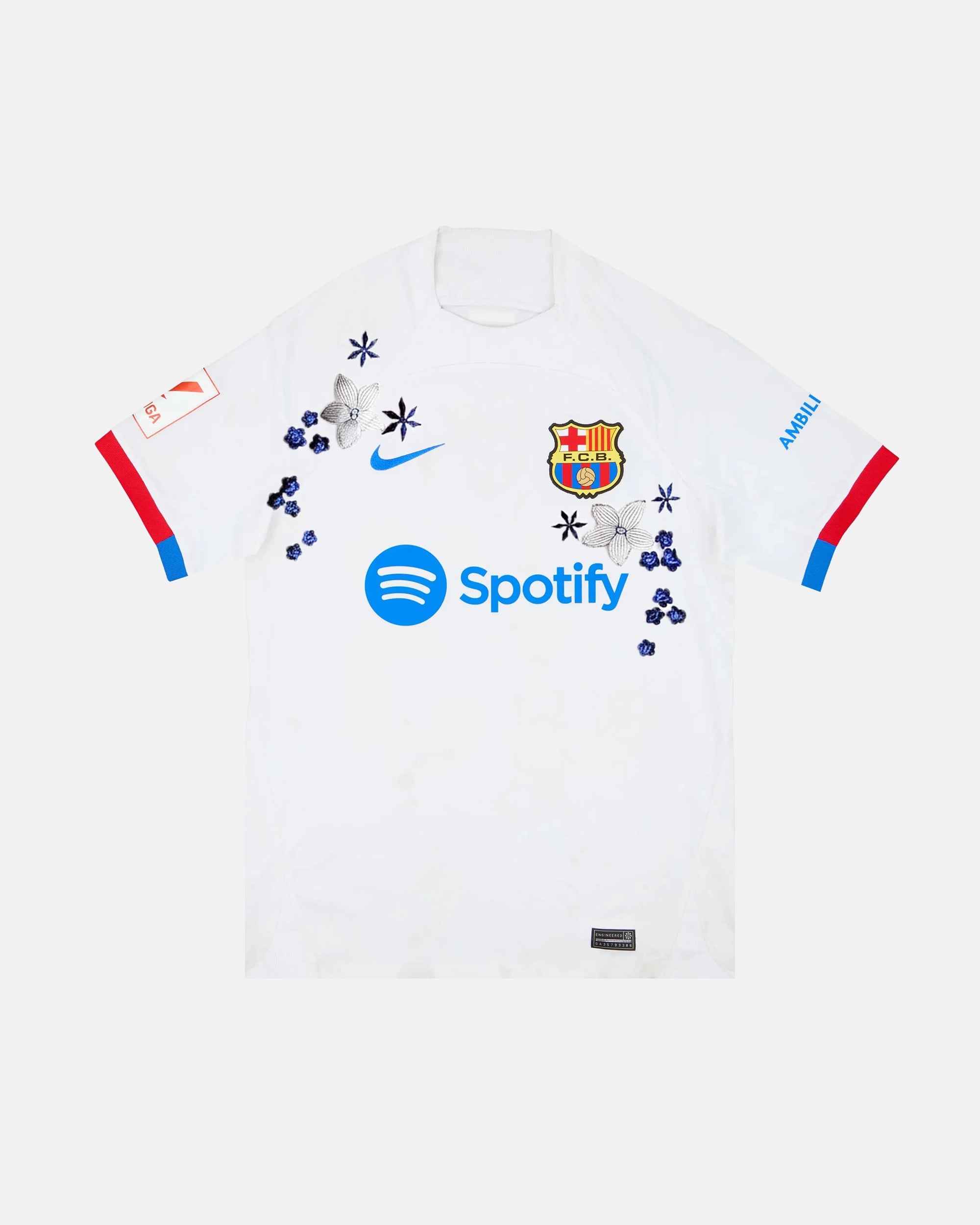 Full Front View Of The Bespoke Barcelona Embroidered Jersey (Azulejo White Edition), Showcasing The White Base Decorated With Hand-Stitched Silver Lilies and Cobalt Flowers.