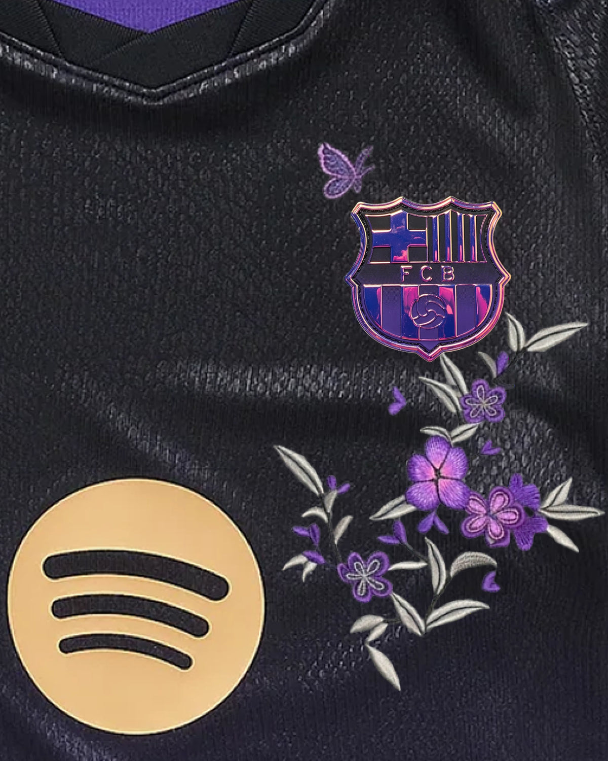 Hand-embroidered butterfly and flowering branch on the right chest of the Barcelona jersey
