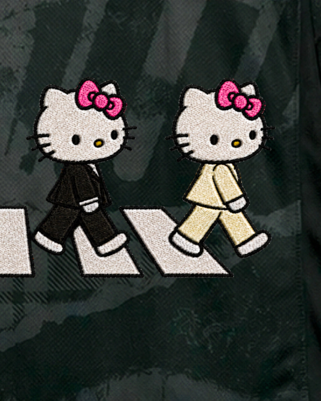 Close-up of hand-embroidered black-suit and cream-suit cat characters — Chelsea ‘Abbey Cats’ Edition — VOLTA Paris