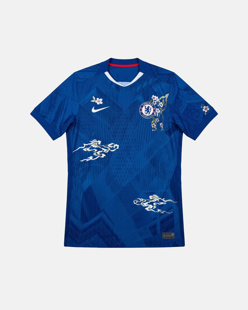 Full Front View Of The Bespoke Chelsea Embroidered Jersey (Edo Blossom Edition), Showcasing The Royal Blue Geometric Base Decorated With Hand-Stitched Pink Sakura And White Clouds.