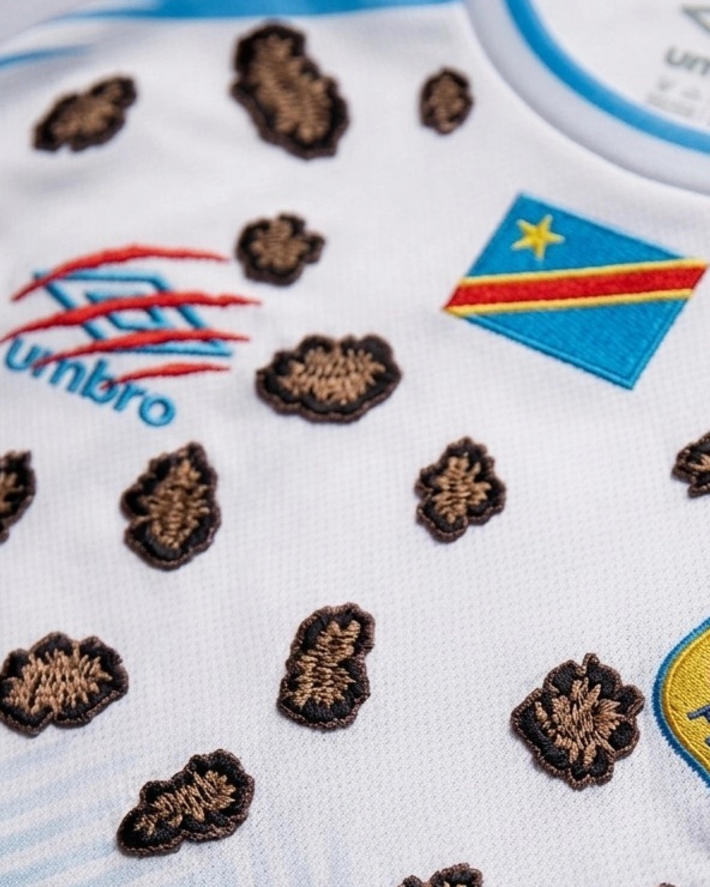 Close-Up Macro Shot Focus On The Right Chest of The Custom Leopard Print Congo Football Shirt, Highlighting The High-Density Crimson Red Claw-Mark Embroidery.