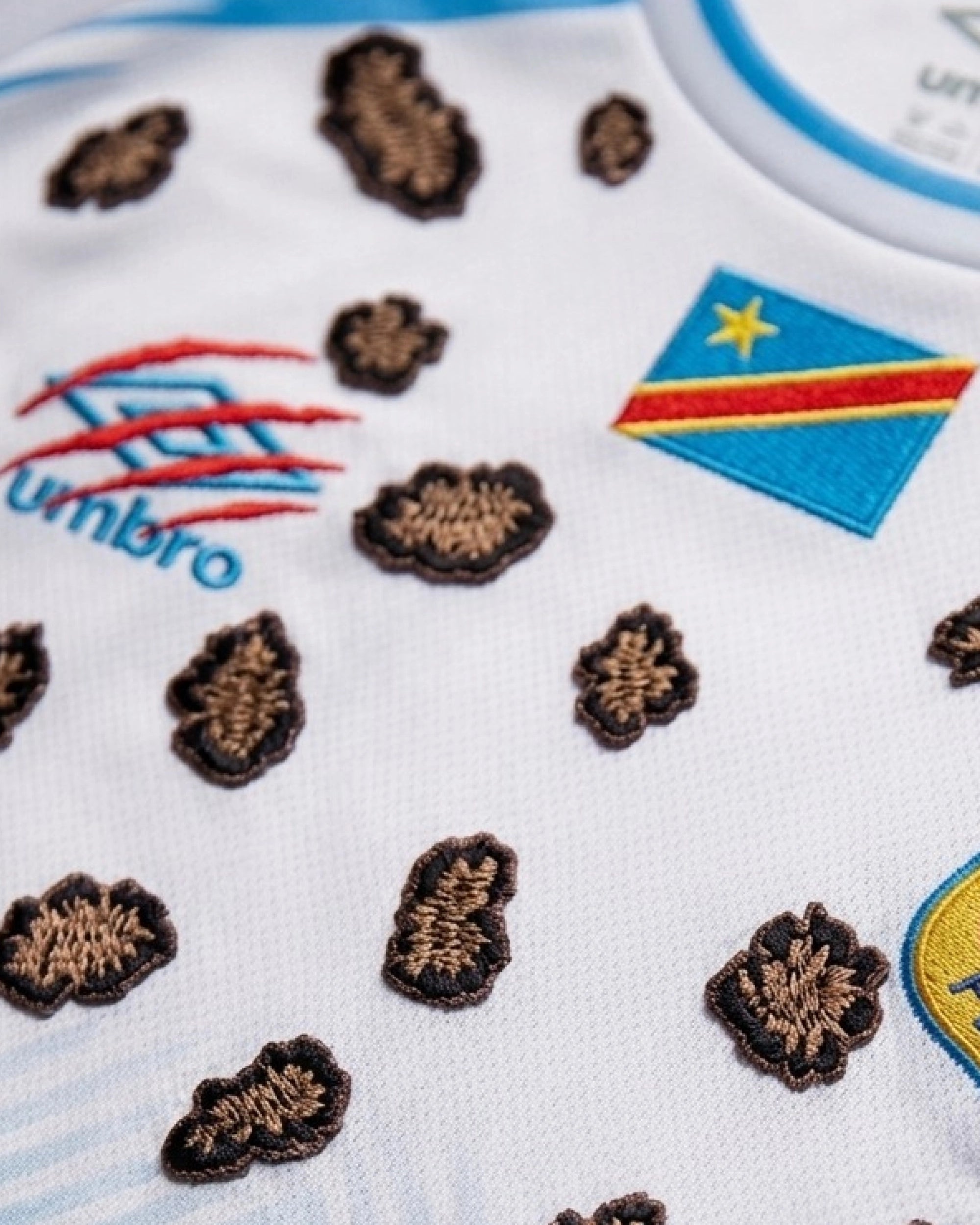 Close-Up Macro Shot Focus On The Right Chest of The Custom Leopard Print Congo Football Shirt, Highlighting The High-Density Crimson Red Claw-Mark Embroidery.