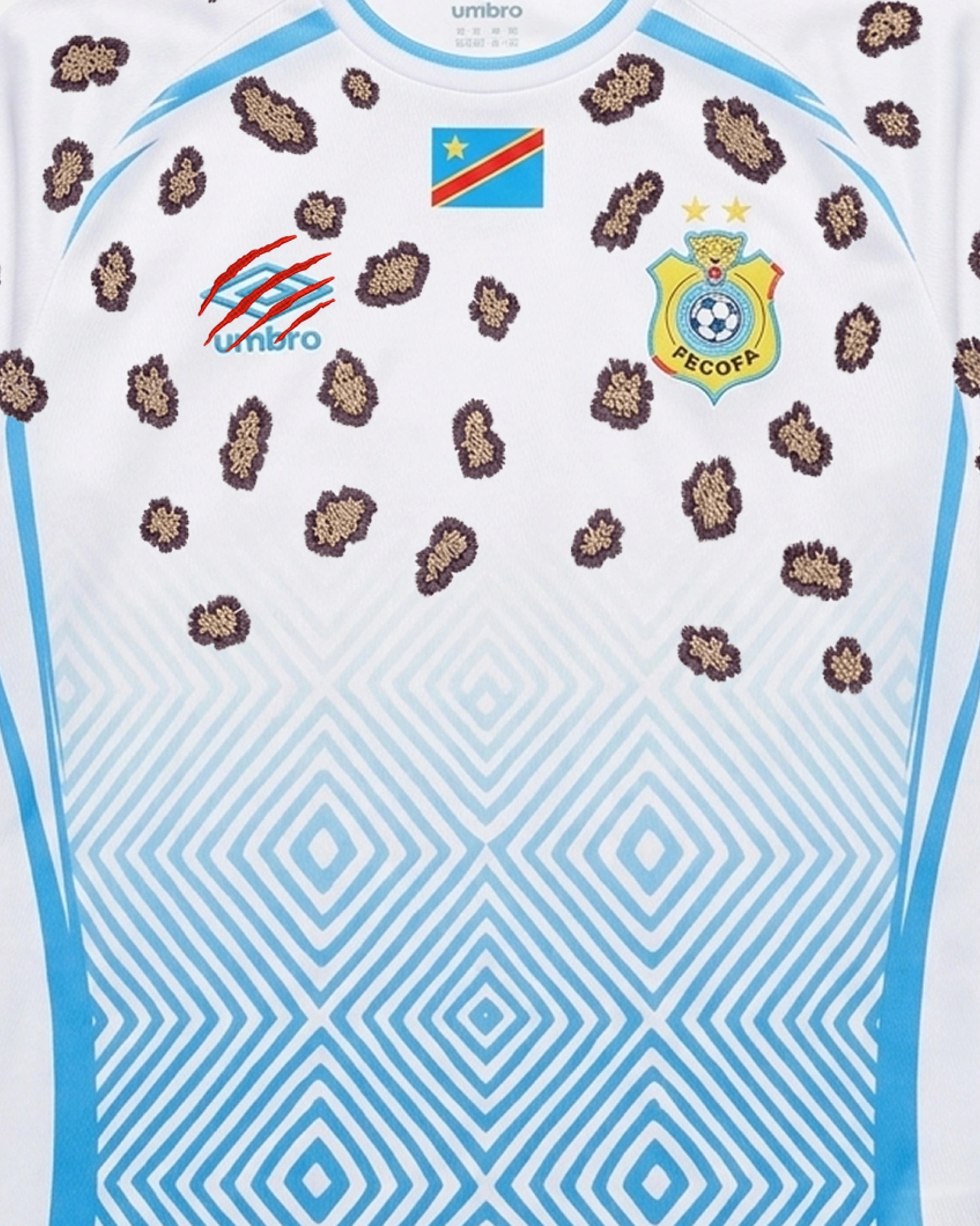 Mid-Range Chest Composition Shot Of The DR Congo Embroidered Jersey 2026, Showcasing The Flag, FECOFA Crest, And Slashed Crimson Brand Logo Amidst Leopard Rosettes.