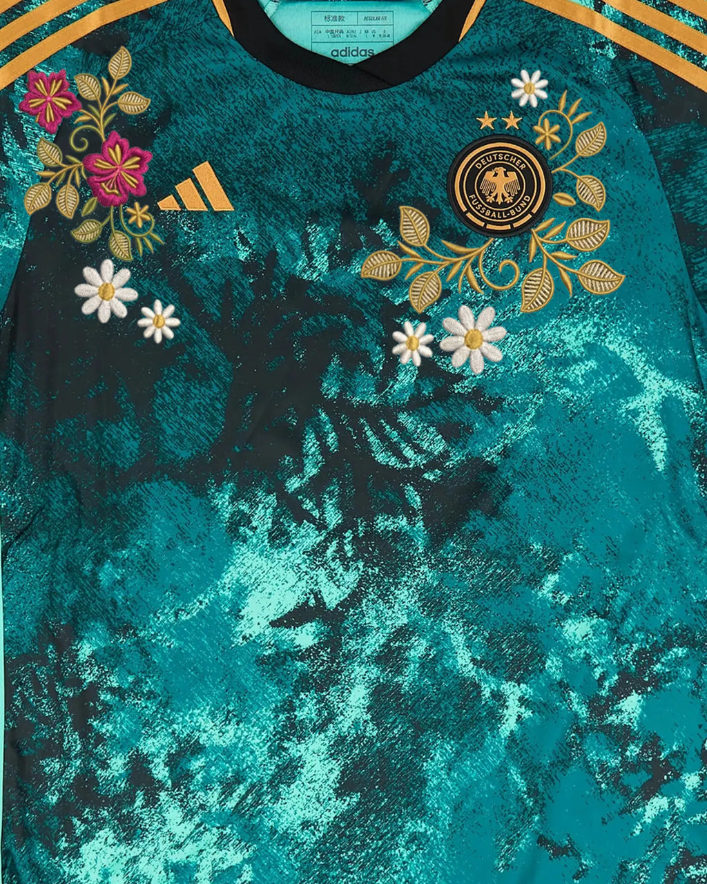 Close-up of hand-embroidered folk floral bouquet in fuchsia and gold — Germany 'Schwarzwald' Edition — VOLTA Paris
