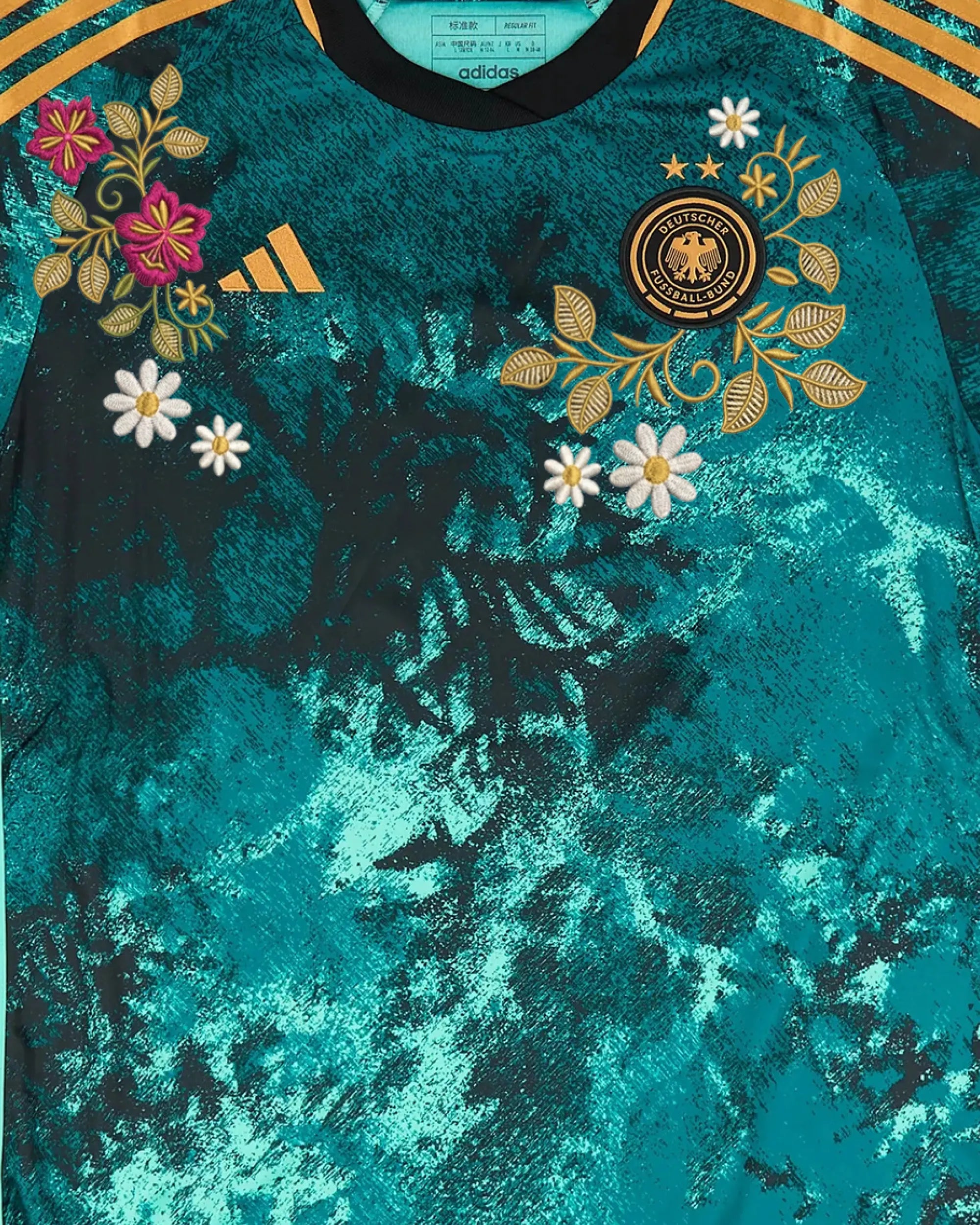 Close-up of hand-embroidered folk floral bouquet in fuchsia and gold — Germany 'Schwarzwald' Edition — VOLTA Paris