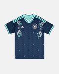 Full Front View Of The Bespoke Germany World Cup 2026 Jersey Reimagined, Showcasing The Navy Chevron Base, Mint Cuffs, and Silver Alpine Edelweiss Embroidery.