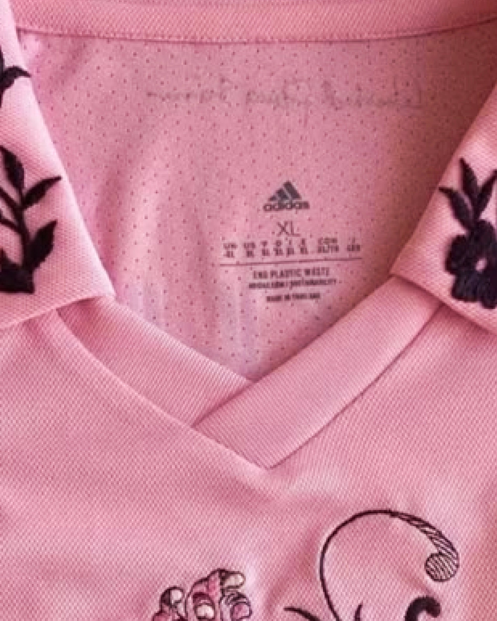 Close-Up Macro Detail Of The V-Neck Polo Collar On The Inter Miami Messi Jersey Revisited, Highlighting Custom Hand-Stitched Leaf Branches Embroidered Onto The Pink Collar Wings.