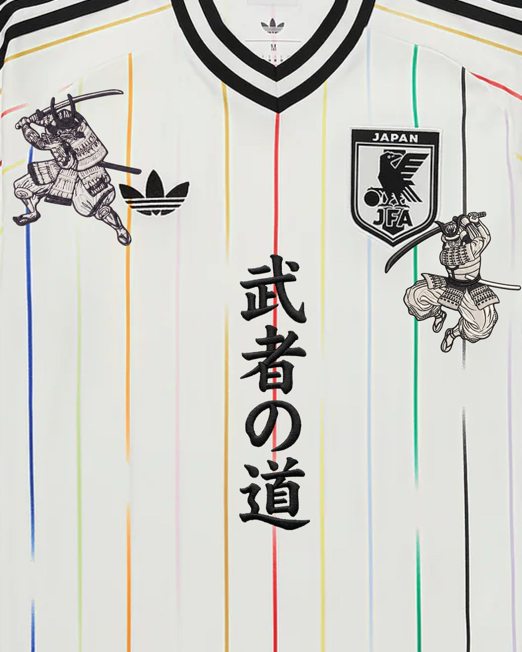 Medium Chest Shot Detail Of The Japan Heritage Kit Revisited, Showcasing Symmetrical Embroidered Samurai Warriors Flanking The Central Black Bushido Calligraphy.