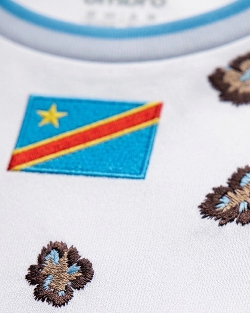 Macro Lens Focus Centered On The Leopards DRC Luxury Football Kit National Flag, Detailing The Heavy Sky-Blue, Yellow, And Red Embroidery Texture.