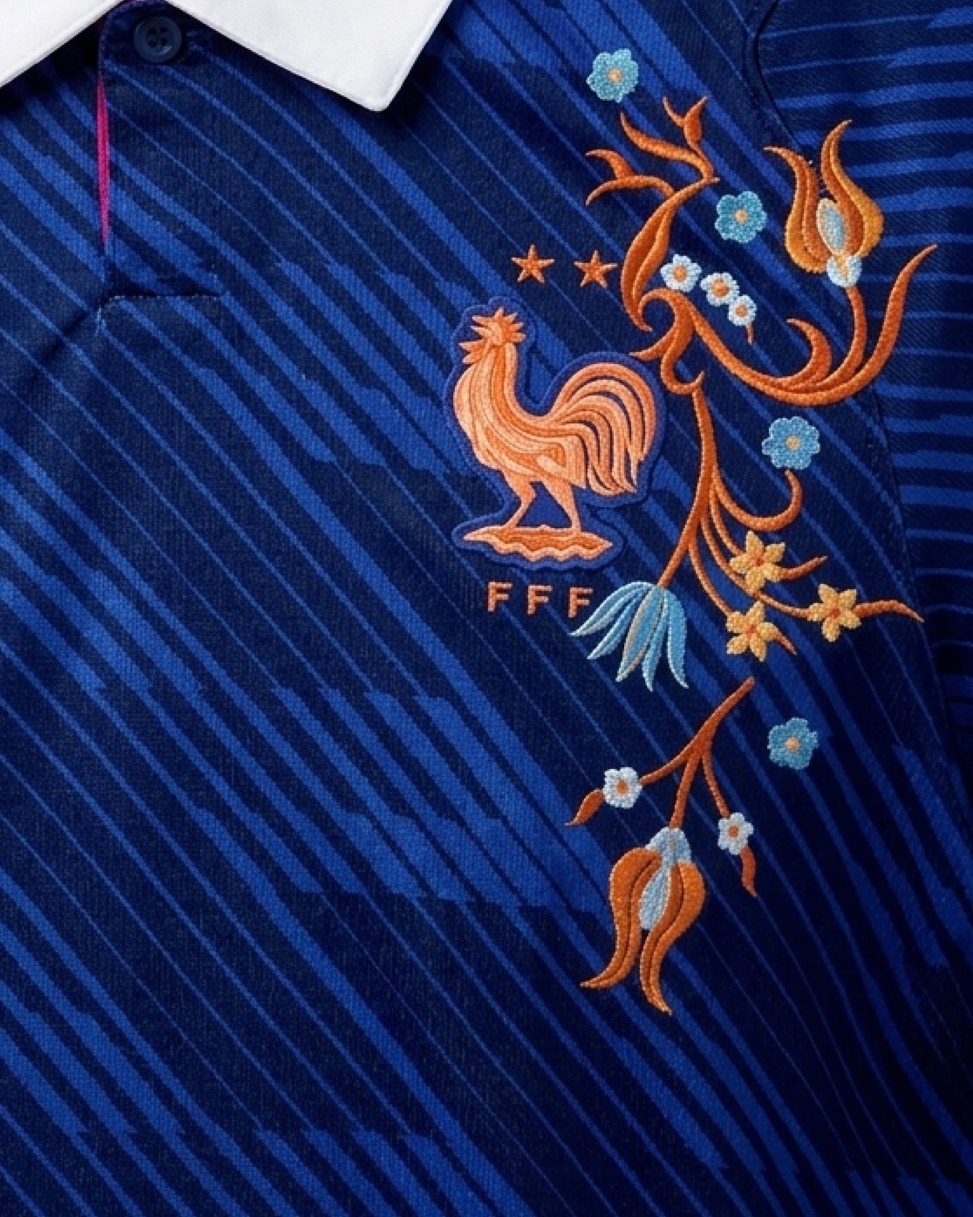 Macro Texture Shot Focusing On The Left Chest Emblem, Showcasing The Traditional French Rooster FFF Crest Enveloped In Exquisite Copper and Azur Blue Artisan Embroidery.