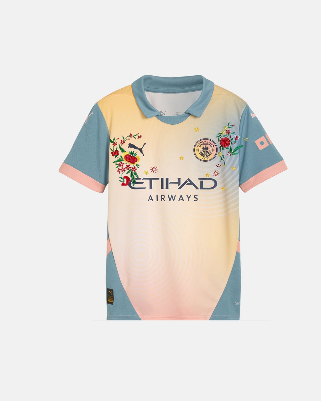 Full Front View Of The Bespoke Manchester City Embroidered Jersey (Madchester Bloom Edition), Showcasing The Peach Gradient Base Decorated With Hand-Stitched Crimson And Yellow Flowers.