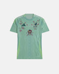 Full Front View Of The Bespoke Mexico Embroidered Jersey (Calavera Edition), Showcasing The Mint Green Aztec-Patterned Base Decorated With A Hand-Stitched Sugar Skull and Magenta Flowers.