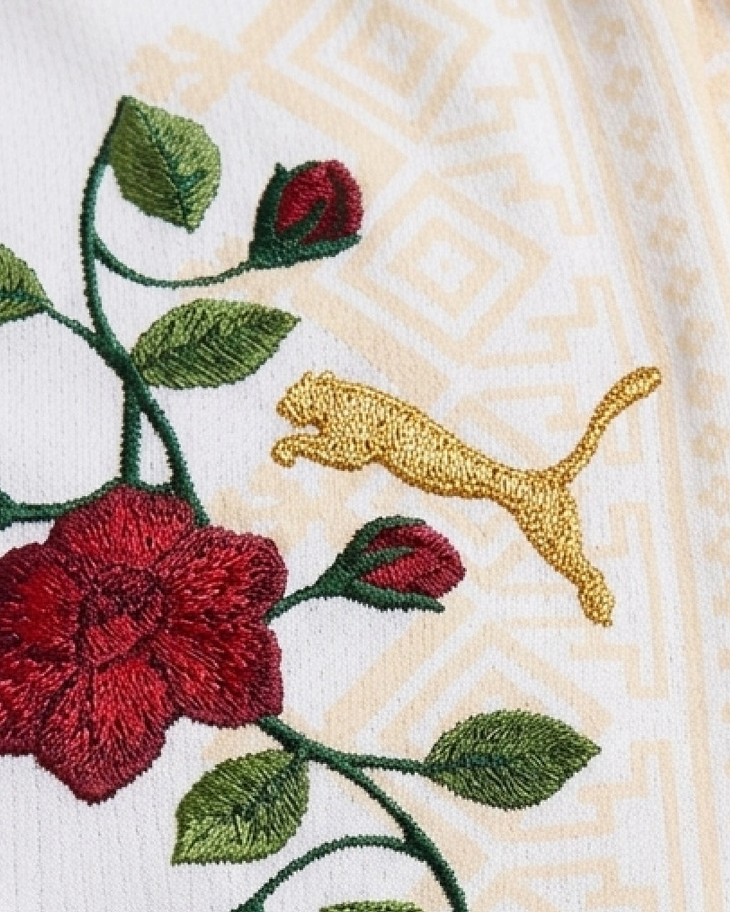 Detailed view of hand-embroidered ascending rose branch with buds and green leaves — Morocco 'Atlas Rose' Edition — VOLTA Paris