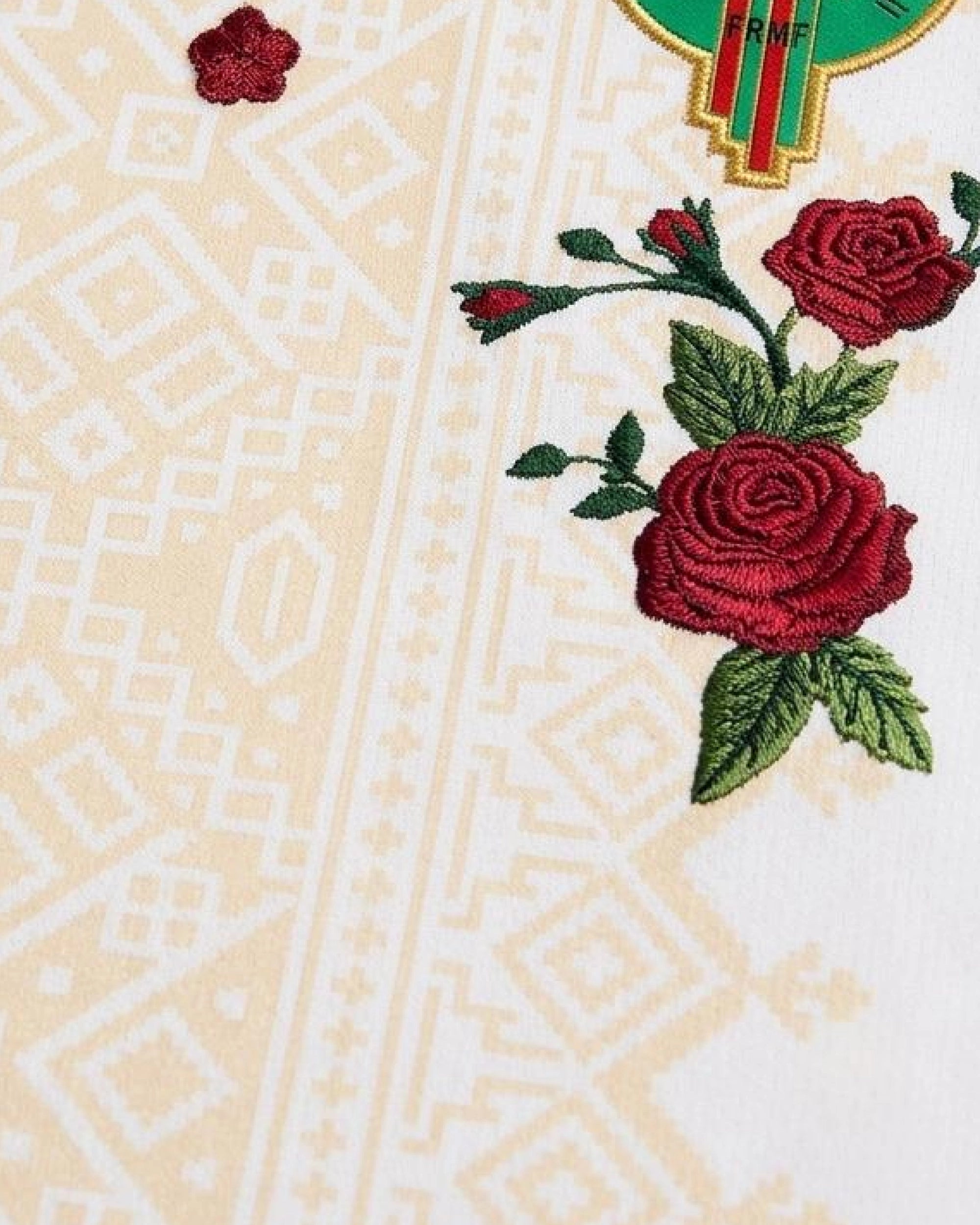 Hand-embroidered double rose bouquet beside FRMF badge on Morocco 'Atlas Rose' Edition jersey — VOLTA Paris