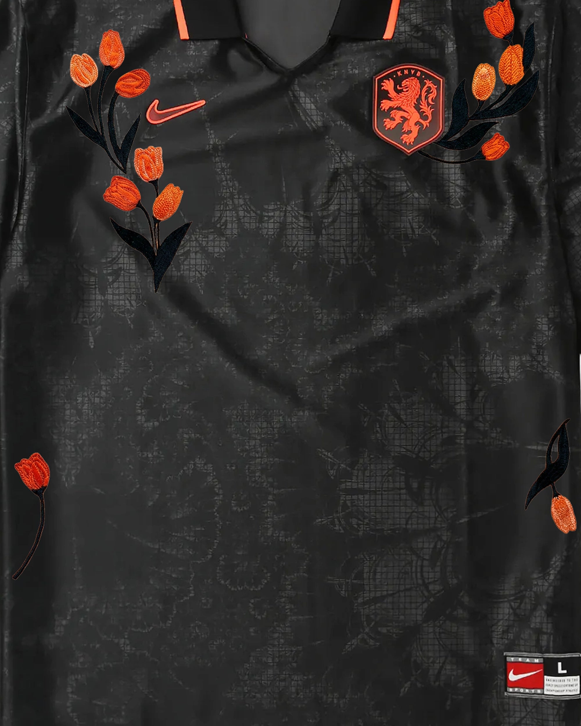 Netherlands KNVB badge with hand-embroidered orange tulip bouquets and black botanical stems on black concept jersey — artisanal embroidery Paris & Versailles — VOLTA Black Tulip Edition