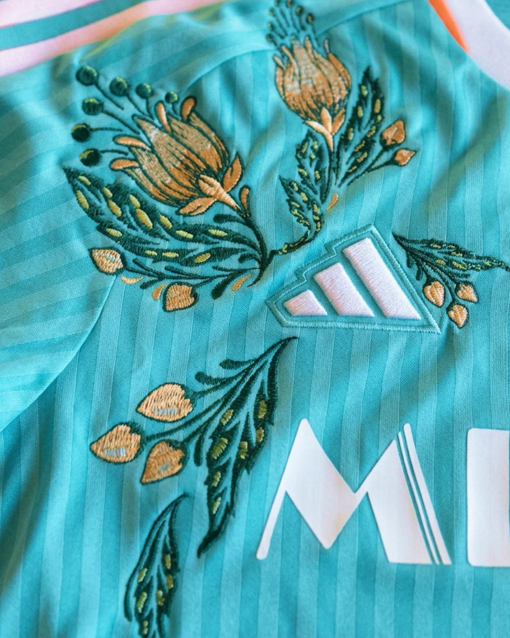 Macro texture shot of the Inter Miami Embroidered Blue Jersey, highlighting the premium haptic 3D quality of the artisan threads on the athletic mesh.