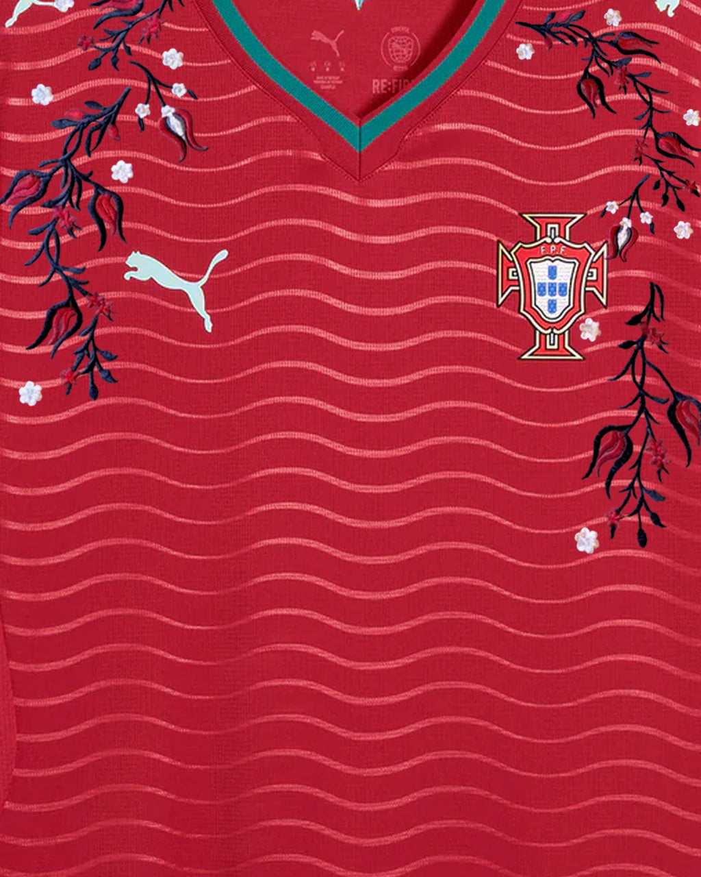 Upper Torso Detail Shot Of The Portugal World Cup Jersey Reimagined, Displaying The Asymmetrical Dark Blue Vines And White Flowers Encasing The Crest And Brand Logo.