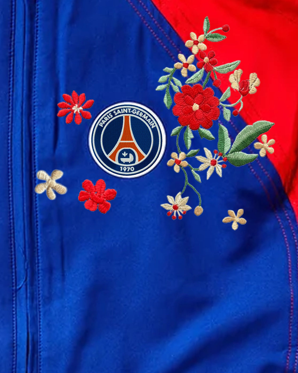 Close-up of hand-embroidered red and cream flower bouquet on PSG track jacket chest