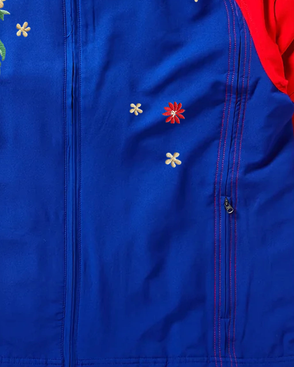 Scattered embroidered blossoms on the front panel of the PSG track jacket