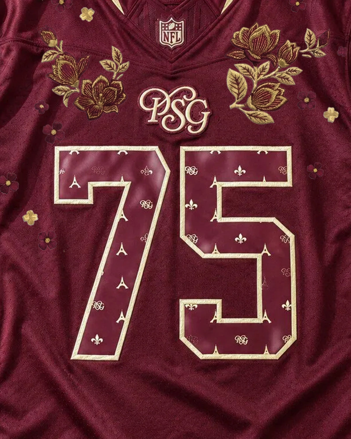 Close-Up Upper Torso Shot Of The PSG x NFL Embroidered Jersey, Displaying The Golden Floral Branches Framing The Calligraphic PSG Logo Above Number 75.