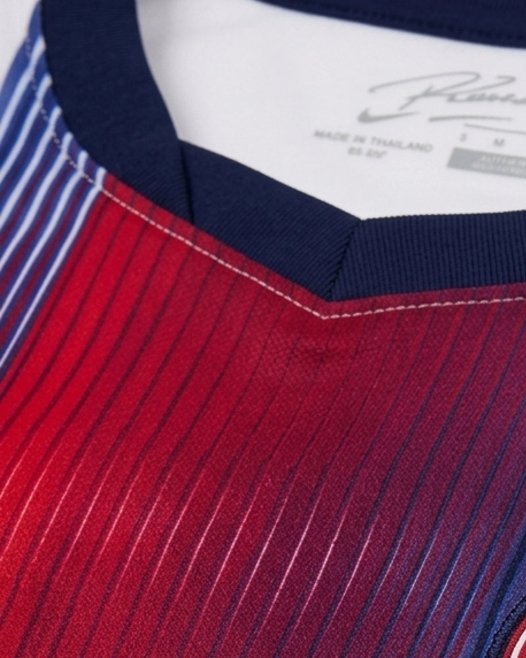 Detailed view of red-to-navy gradient stripe panel and navy V-collar — PSG 'Sang Bleu' Edition — VOLTA Paris