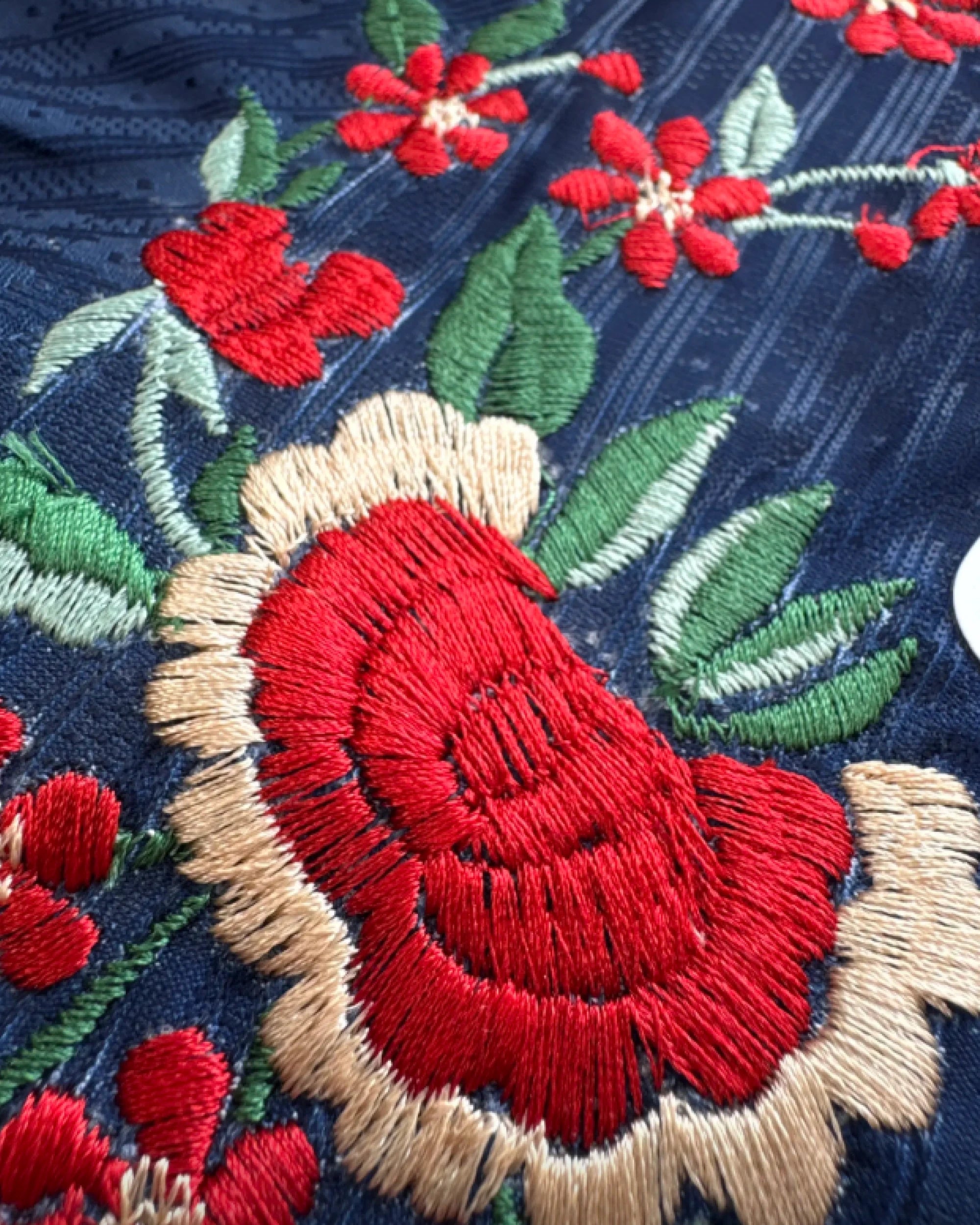 Hand-embroidered red roses and cherry blossoms on PSG jersey — VOLTA Parisian Street Edition detail