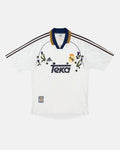 Full Front View Of The Bespoke Real Madrid Embroidered Jersey (Castilian Thistle Edition), Showcasing The White 1999/2000 Base Woven With Hand-Stitched Purple Thistles.