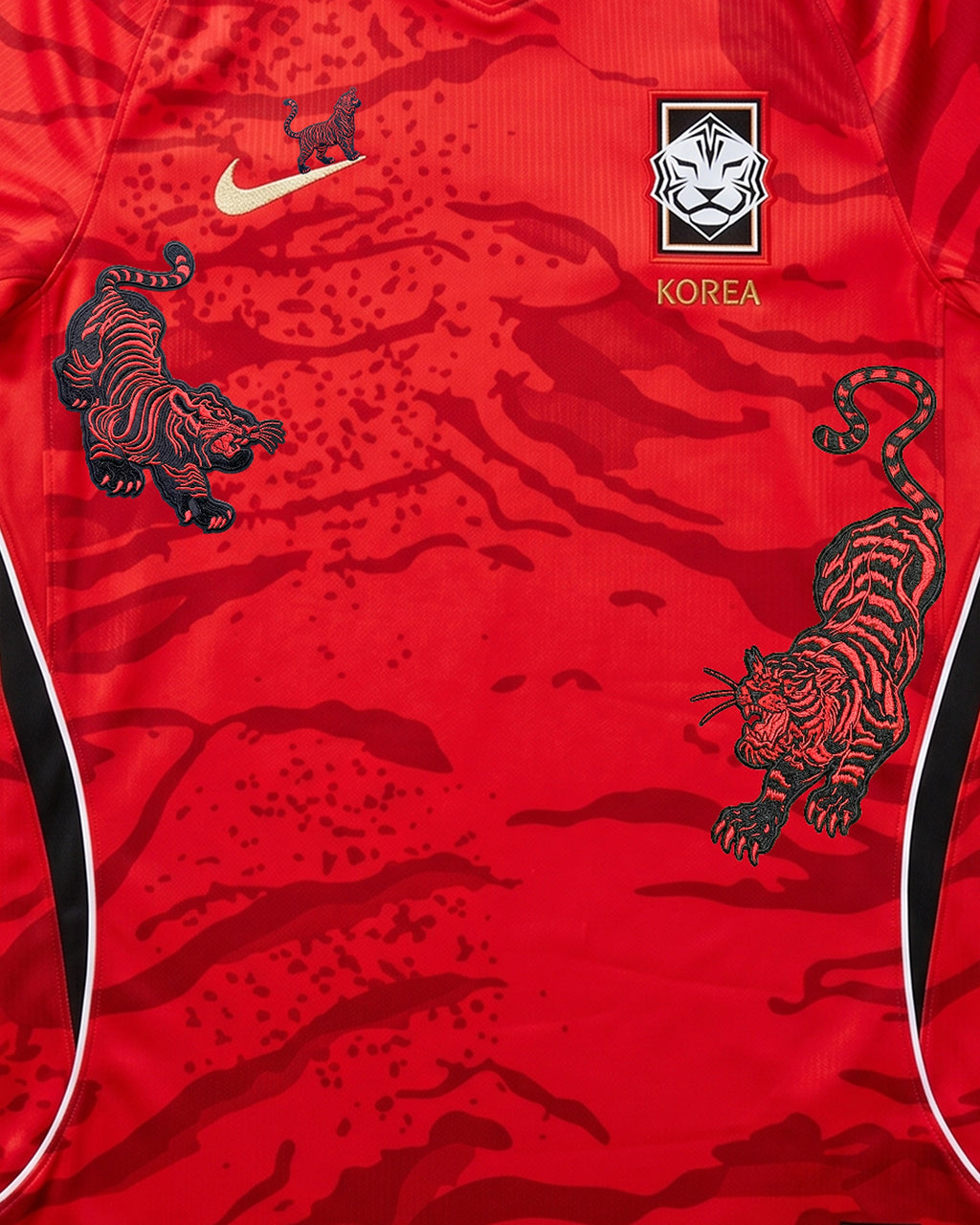 Medium Chest Shot Detail Of the South Korea 2026 Jersey Reimagined, Showcasing Premium Black, Red, and Gold Tiger Embroidery Flanking The Crest and Logo.